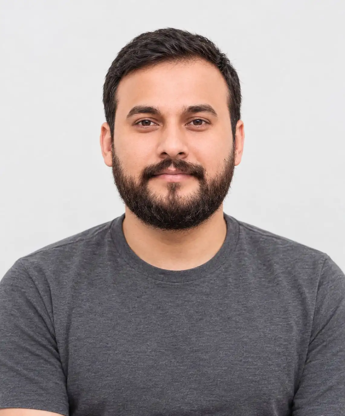 Kashif Bhatti, backend developer, smiling in a grey T-shirt